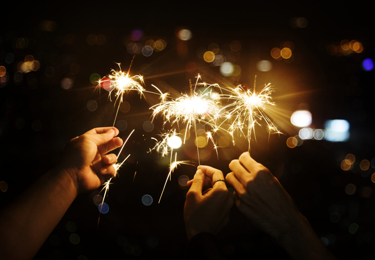Free photo celebrating with sparklers in the night